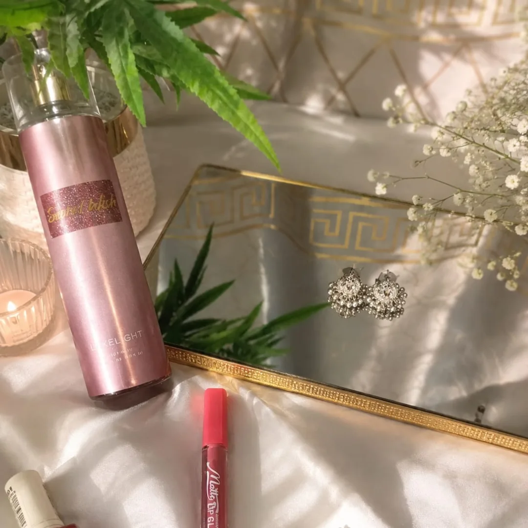 Perfume bottle and mirror styled with florals